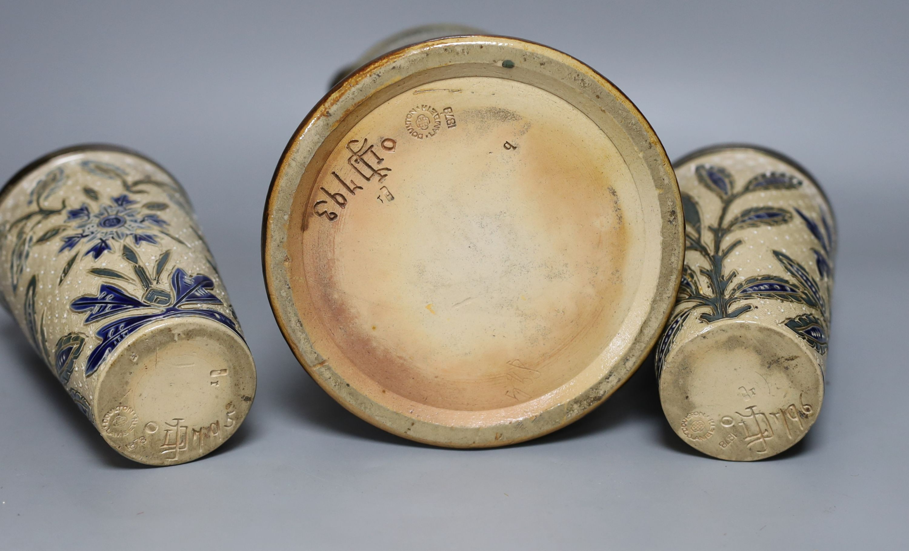A silver mounted Doulton Lambeth jug by Louisa J Davis, 26.5cm tall, and a pair of matching beakers